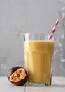 Fruit protein shake on a white wooden table. Fresh milkshake with passion fruit. A glass of protein shake Royalty Free Stock Photo