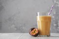 Fruit protein shake on a white wooden table. Fresh milkshake with passion fruit. A glass of protein shake Royalty Free Stock Photo