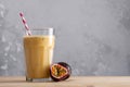 Fruit protein shake on a wooden table. Fresh milkshake with passion fruit. A glass of protein shake Royalty Free Stock Photo