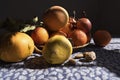 Fruit pumpkin, oranges, and nuts stilllife on a table cloth sunny and shady