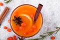 Fruit punch with sea buckthorn berries, citrus and spices in a glass cup