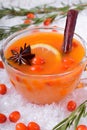 Fruit punch with sea buckthorn berries, citrus and spices in a glass cup