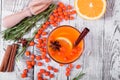 Fruit punch with sea buckthorn berries, citrus and spices in a glass cup