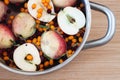 Fruit punch with sliced half apples and buckthorn berries in cooking pot macro