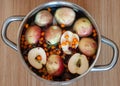 Fruit punch with sliced half apples and buckthorn berries in metal cooking pot