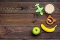 Fruit puree for baby. Jar with food, apple, banana, toys on dark wooden background top view copy space Royalty Free Stock Photo