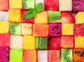 Fruit puzzle. Colorful food background or pattern arranged of different fruit cubes. Dietary concept Royalty Free Stock Photo