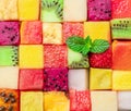 Fruit puzzle. Colorful food background or pattern arranged of different fruit cubes. Dietary concept Royalty Free Stock Photo