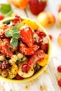 Fruit salad with the addition of quinoa, honey, lemon juice and fresh mint