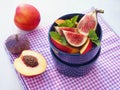 Fruit salad. Assorted purple fruits in a blue bowl. Healthy eating concept.