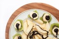 Fruit salad with banana and kiwi topped with chocolate cream Royalty Free Stock Photo