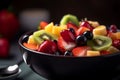 Fruit salad in black bowl close up, summer fresh food. Generative AI Royalty Free Stock Photo