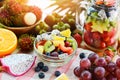 Fruit salad bowl fresh summer fruits and vegetables healthy organic food strawberries orange kiwi blueberries dragon fruit