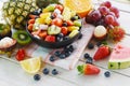 Fruit salad bowl fresh summer fruits and vegetables healthy organic food watermelon strawberries orange kiwi blueberries dragon Royalty Free Stock Photo