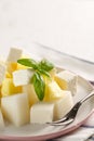 Fruit salad with cheese. Mango, melon with cheese and Basil Royalty Free Stock Photo