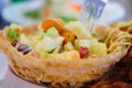 Fruit salad cream in taro basket Royalty Free Stock Photo