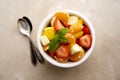 Fruit salad with fresh apple, strawberry, tangerines, pineapple and honey. Diet and healthy eating Royalty Free Stock Photo