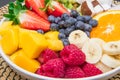 Fruit salad with fresh berries, orange, coconut, mango, and sliced of banana Royalty Free Stock Photo