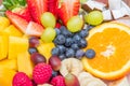 Fruit salad with fresh berries, orange, coconut, mango, and sliced of banana Royalty Free Stock Photo