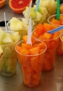 Fruit salad of fresh melon cubes in plastic cups Royalty Free Stock Photo