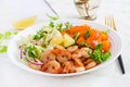 Fruit salad with fried prawns / shrimps, persimmon, red onion and lettuce in white bowls. Royalty Free Stock Photo