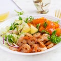 Fruit salad with fried prawns / shrimps, persimmon, red onion and lettuce in white bowls. Royalty Free Stock Photo