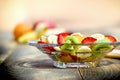 Fruit salad in glass bowl closeup, healthy delicious vegan food Royalty Free Stock Photo