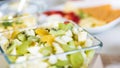 Fruit salad in glass bowl - healthy lunch idea - green grapes, banana, pear, kiwi fruit Royalty Free Stock Photo