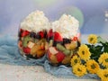 Fruit salad in glasses with cream. Royalty Free Stock Photo