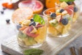 Fruit salad in glasses,  fresh summer foods , healthy organic orange kiwi blueberries pineapple coconut Royalty Free Stock Photo