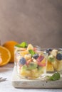 Fruit salad in glasses,  fresh summer foods , healthy organic orange kiwi blueberries pineapple coconut. top view Royalty Free Stock Photo