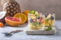 Fruit salad in glasses,  fresh summer foods , healthy organic orange kiwi blueberries pineapple coconut. top view Royalty Free Stock Photo
