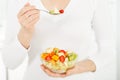 Fruit salad in the hands of women. Royalty Free Stock Photo