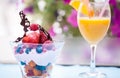 Closeup shot of vanilla ice cream with berries and fruits and a glass of orange juice Royalty Free Stock Photo
