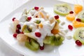 Fruit salad with ice cream on a white plate closeup Royalty Free Stock Photo