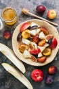 Fruit salad of melon, figs, apples and plums on a dark rustic background, top view. flat lay. Royalty Free Stock Photo
