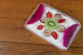 Fruit salad of melon, grape, strawberry, kiwi dressed with natural yoghurt