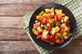 Fruit salad with orange, kumquat, pineapple, carambola, grapefruit, plum and kiwi close-up. Horizontal top view Royalty Free Stock Photo