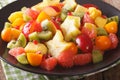 Fruit salad with orange, kumquat, pineapple, carambola, grapefruit, plum and kiwi close-up. horizontal Royalty Free Stock Photo