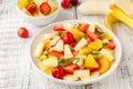 Summer fruit salad in a plate of chopped strawberries, kiwi, banana, orange and cherry Royalty Free Stock Photo