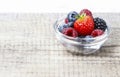 Fruit salad in small transparent bowl on wooden table Royalty Free Stock Photo