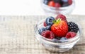Fruit salad in small transparent bowl on wooden table Royalty Free Stock Photo