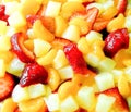 Fruit salad with strawberries, oranges and peaches for background