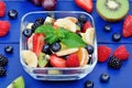 Fruit salad in a transparent bowl on wooden background Royalty Free Stock Photo