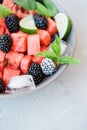 Fruit salad from Watermelon slices, frozen blackberry and lime o Royalty Free Stock Photo