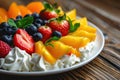 Fruit salad with whipped cream and fresh berries on a wooden table Royalty Free Stock Photo