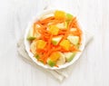 Fruit salad on white wooden table, top view Royalty Free Stock Photo