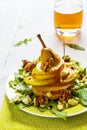 Fruit salad, whole pear sliced, walnuts caramelized in honey, blue cheese and arugula. Green plate on white wooden table Royalty Free Stock Photo