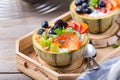 Fruit salad with yogurt in carved melon cantaloupe bowl Royalty Free Stock Photo