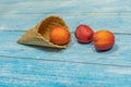 Fruit season. Fruit ice cream. Apricot in a waffle on a blue wooden background